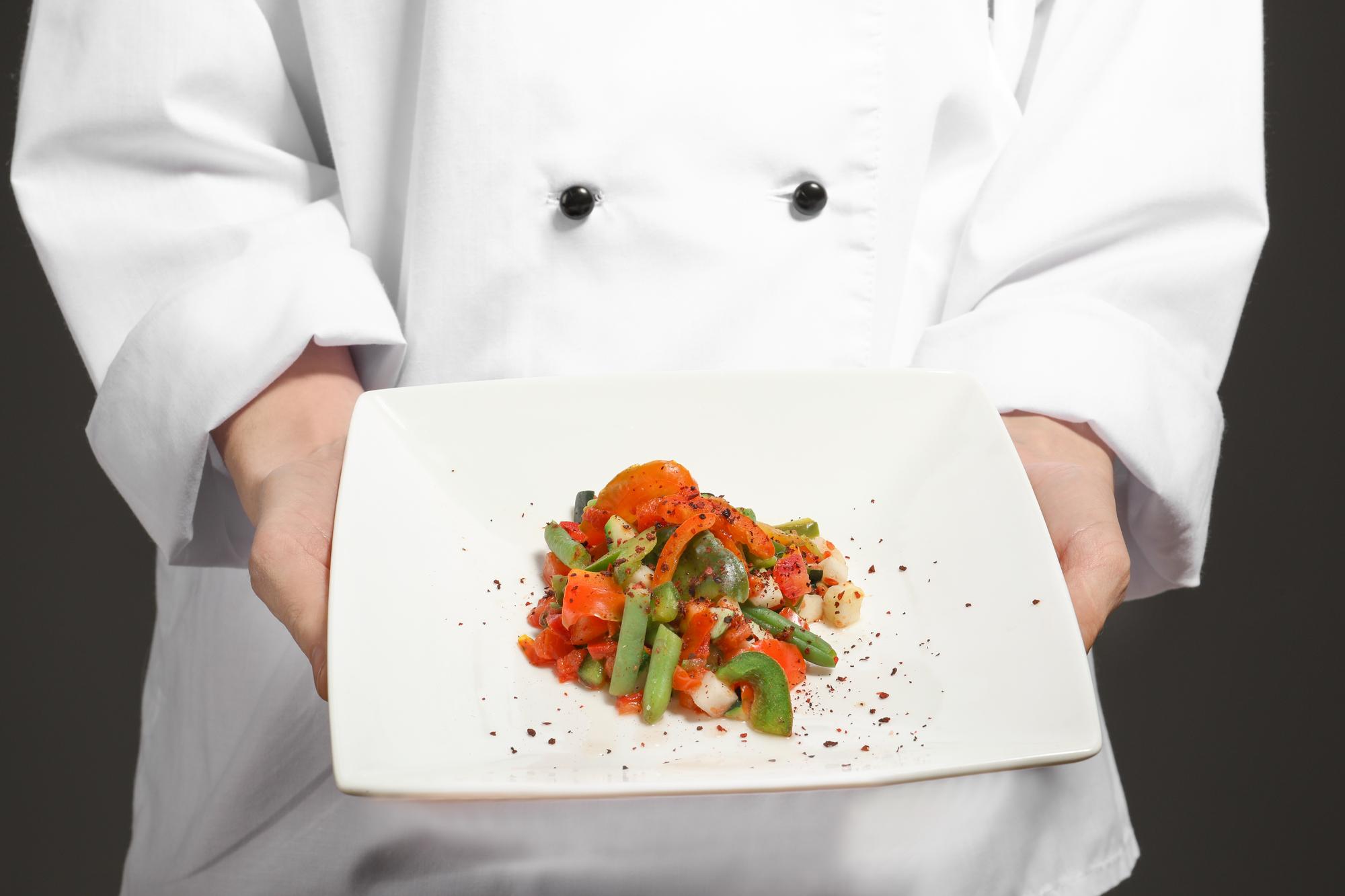 Instructor demonstrating plating in kitchen